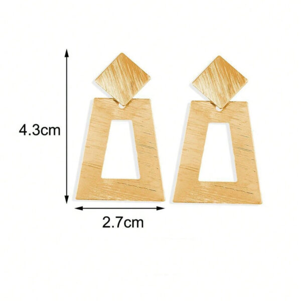 Eclat Newyork's Simple Geometric Earrings with brushed gold-tone squares and diamond shapes, lying on a soft beige background.