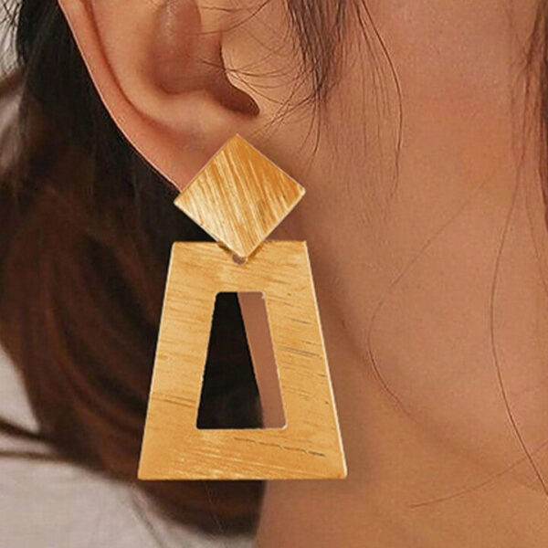 Eclat Newyork's Simple Geometric Earrings with brushed gold-tone squares and diamond shapes, lying on a soft beige background.