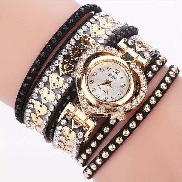 Eclat Newyork Heart-shaped bracelet watch with a black wraparound strap, an attractive gold-detailed watch face, and rhinestone and golden heart embellishments.