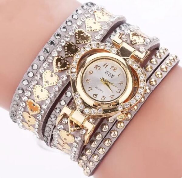 Eclat Newyork Heart-shaped bracelet watch with a Grey wraparound strap, an attractive gold-detailed watch face, and rhinestone and golden heart embellishments.