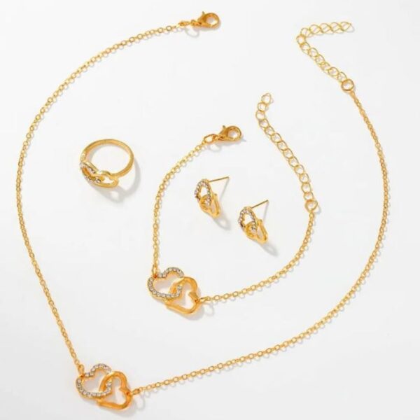 The Eclat Newyork's 6PCS Women's Gold Watch and Heart Jewellery Set comes with a bracelet, pendant necklace, earrings, ring, and gold-tone watch.