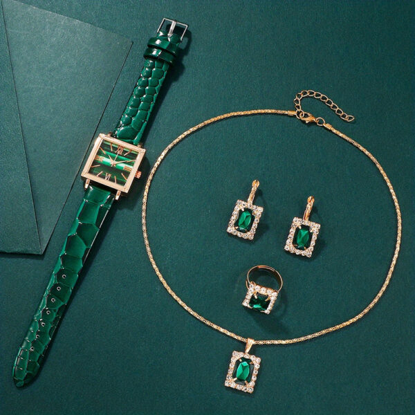 Eclat Newyork' 5-piece women's quartz watch and emerald pendant jewellery set is beautifully presented on a jewellery display.