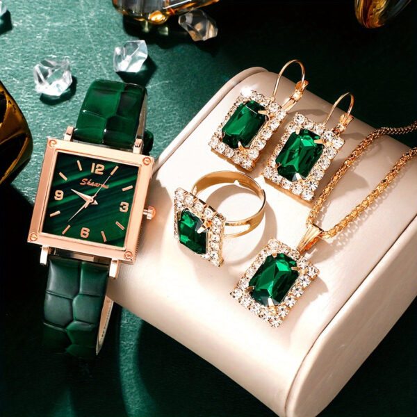 Eclat Newyork' 5-piece women's quartz watch and emerald pendant jewellery set is beautifully presented on a jewellery display.