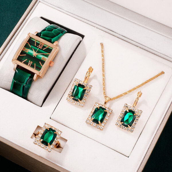 Eclat Newyork' 5-piece women's quartz watch and emerald pendant jewellery set is beautifully presented on a jewellery display.