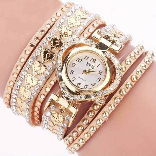 Eclat Newyork Heart-shaped bracelet watch with a Golden wraparound strap, an attractive gold-detailed watch face, and rhinestone and golden heart embellishments.